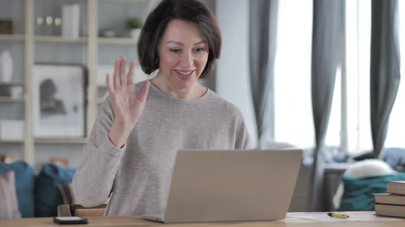 Online Video Chat on Laptop at Work By Senior Woman