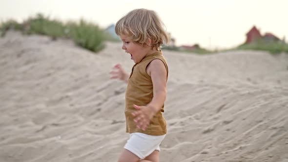 Cute Little Boy on Sandy Sea Beach