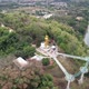Aerial view by drone of the big buddha statue and skywalk by the Mekong river in Loei, Thailand - VideoHive Item for Sale