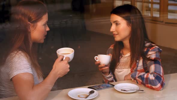 Beautiful women interacting with each other while having coffee
