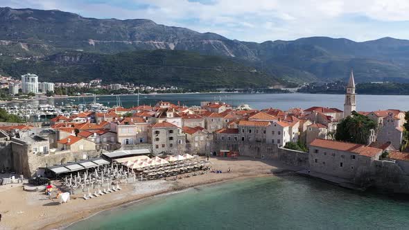 Aerial shot of Old Town of Budva in Montenegro, on a Adriatic seaside. Sunny day, blue sky with clou