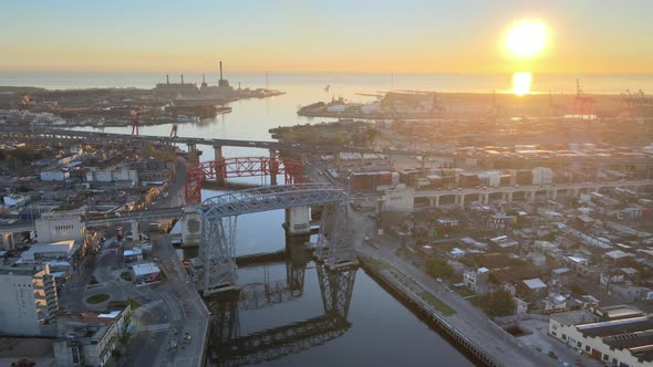 Cinematic harbour view capturing transporter bridges over Riachuelo Matanza river with beautiful sun