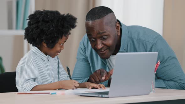 African American Family Kid Girl Sitting in Room at Desk Doing Homework Father Approaches and Points