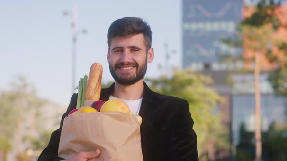 Young Man Posing with a Big Eco Bag with Food in