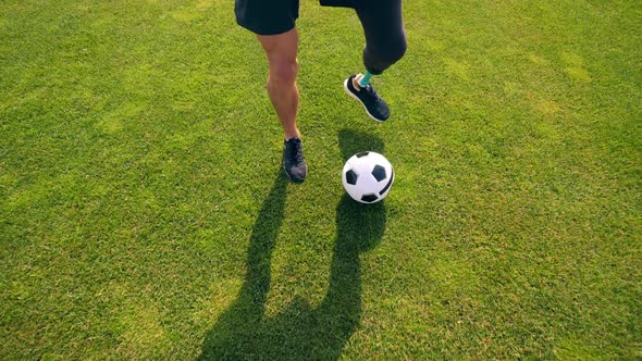 Green Lawn with a Physically Challenged Man Playing Soccer, Football