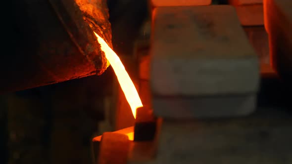 Molten metal being poured in mold at foundry workshop 4k