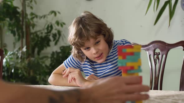 Exciting Small Boy Play Game with His Brother. Boys Playing Jenga