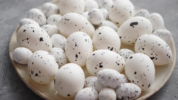 Composition of White Traditional Dotted Easter Eggs in White Ceramic Plate