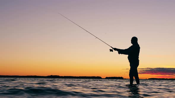 Fisherman Is Catching Fish at Sundown