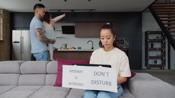 Asian Caring Father Babysitting Daughter While Mom Working