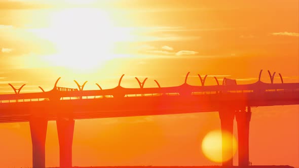 Bridge Over River Lit By Orange Setting Sun Light Timelapse