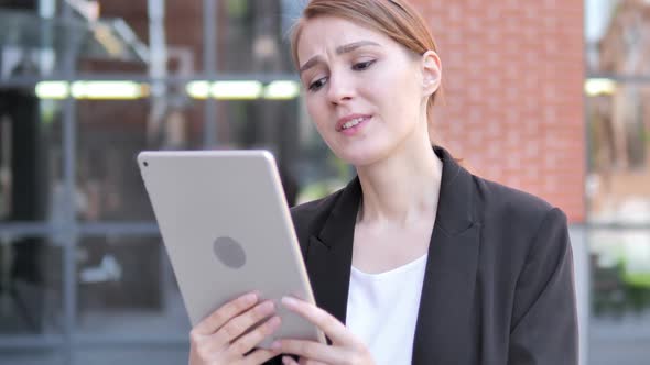 Outdoor Young Businesswoman Upset By Loss on Tablet