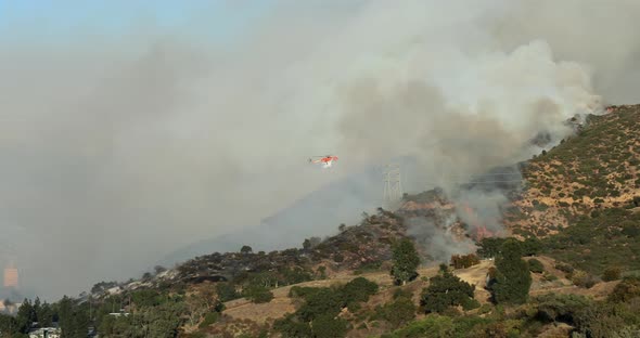L.A. County Fire Department Helicopter Rushes To the Burning Hollywood Hills. California. USA