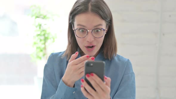 Woman Reacting to Loss on Smartphone