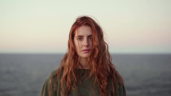 Redheaded woman on viewpoint at sunrise, Ibiza