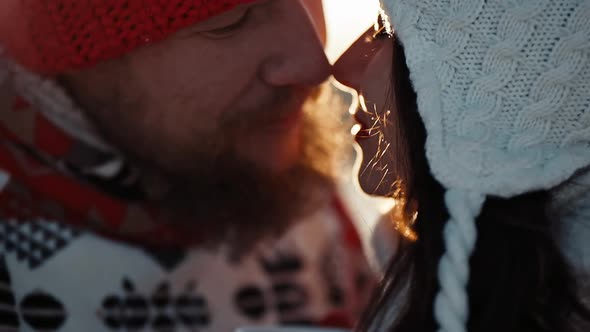 Young Couple in Love Kiss in First Snowy Winter Day and Drink Tea