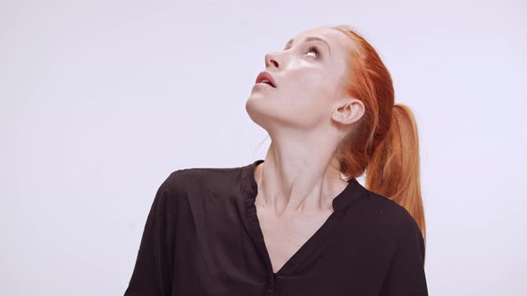 Surprised Young Caucasian Woman with Colored Orange Hair Standing in White Background in Dark Brown