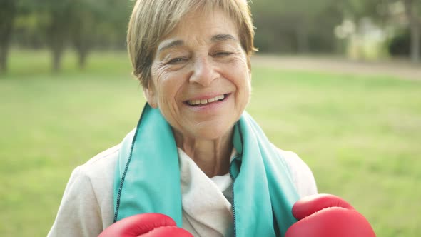 Senior Woman Smiling on Camera After Boxing Training Routing Outdoor at City Park