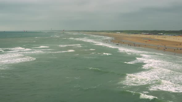 A Turbulent Sea Surface Around a Beach on a Cloudy Day, the Gray Sky in the Background - Top View