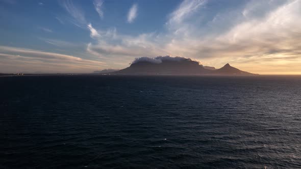 Table Mountain with its famous tablecloth at golden hour; aerial view