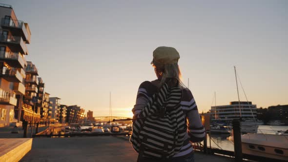 Active Woman Rejoices at Sunrise Over the Marina