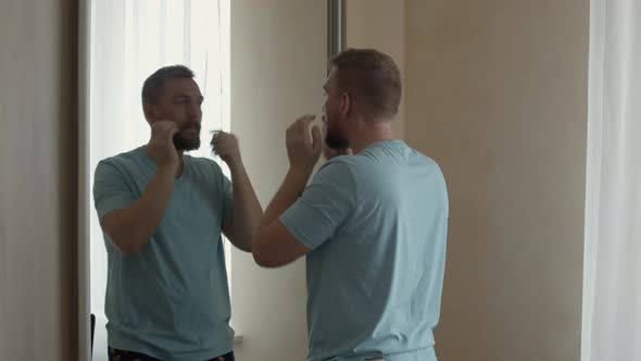 Young Man with a Beard at the Mirror