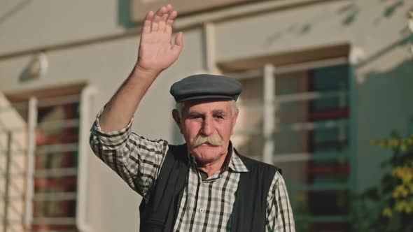 Old Man Waving Hand