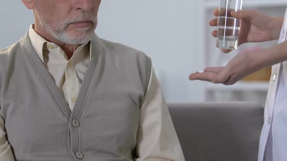 Elderly Man Refusing Pills From Medical Worker, Unwanted Treatment, Health