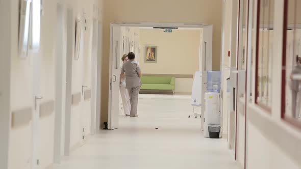 Doctor Walking Down Hospital Hallway