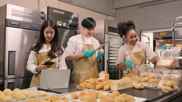 Three young startup partners taking online orders, pastry, and bakery food shop.