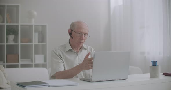 E-learning By Internet, Aged Man Is Lecturing, Sitting Home in Front of Laptop, Communicating Online