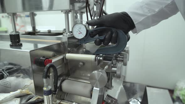 Scientist Hand in Black Glove Pushing Softgel Capsules Using Air Compressor Gun