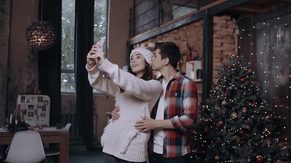 Young Couple Posing with the Front Camera of the Phone While Spending Time at Home Comfortably Next