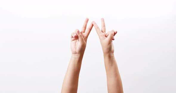 Hand showing two thumbs up scissors victory chroma key isolated on a white studio background with co