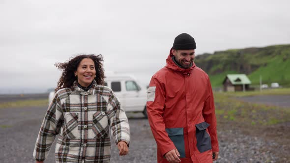 Smiling Couple In Warm Clothing Walking In Thingvellir