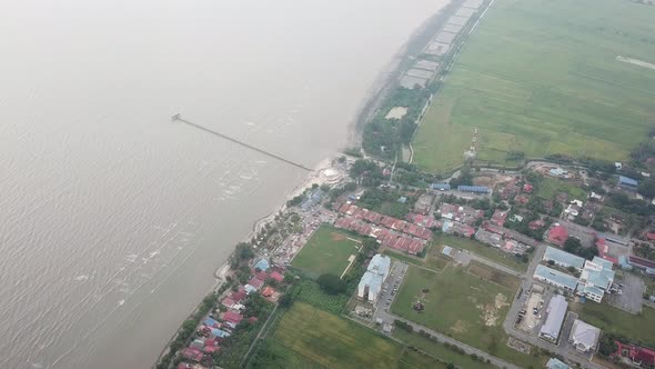 Aerial rotating look down Yan Pantai Murni waterfront 