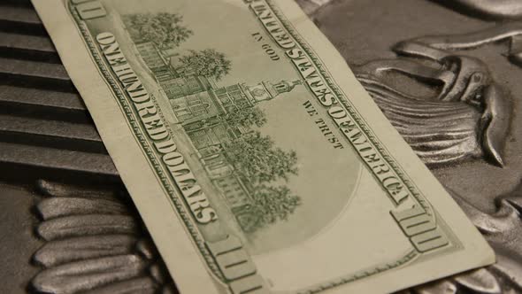 Rotating footage shot of American paper currency on an American eagle shield background