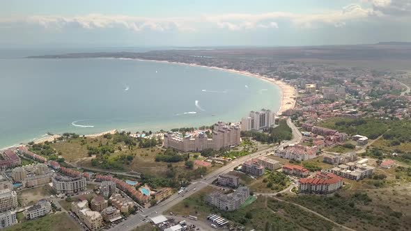 Aerial view of Sunny Beach city that is located on Black Sea shore. Top view of sand beaches with 