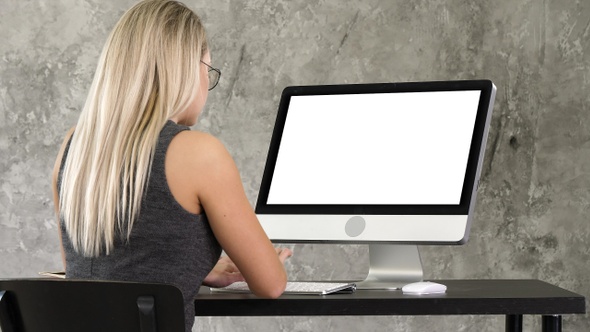 Businesswoman sitting at her desk in the office working