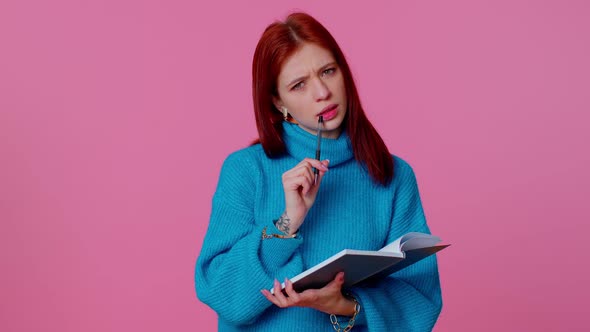 Pensive Ginger Woman Making Notes Writing Down Thoughts with Pen Into Notepad Notebook Diary Indoor