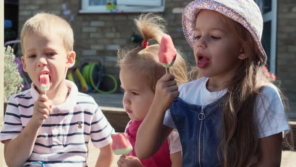 Three Cute Little Children Enjoys Delicious Ice Cream Cone