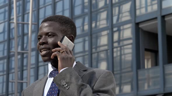 Busy black african business man talking by phone in the city