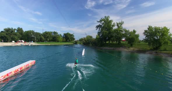 Back view of Man wakeboarding at Wake Park in Zagreb, Croatia