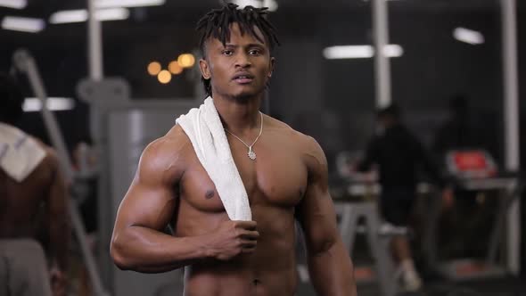 Portrait of Topless African American Man with Towel in Gym