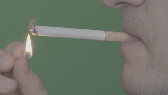 Cigarette in the Mouth of a Smoker. Close-up. Slow Motion