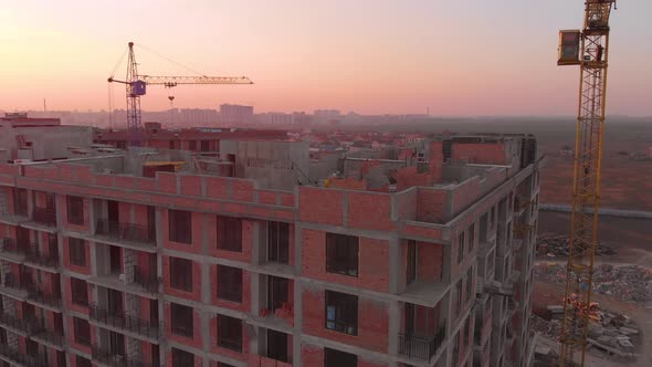 Construction Site in the Middle of the City and Private Houses at Sunset in