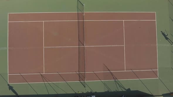 Top View of Tennis Match Between Male and Female, Players Returning Ball in Game
