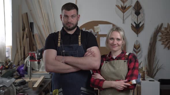 Portrait of a Man and a Woman in a Carpentry Workshop