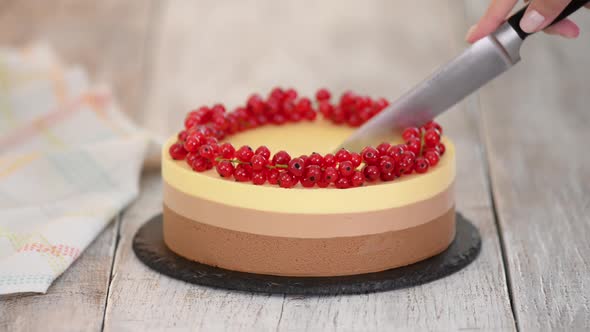 Cutting a Triple Chocolate Mousse Cake with Red Currant