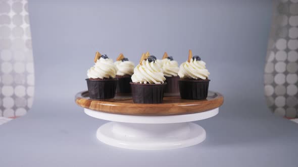 Cupcakes with a Light Cream with Cookies and Berry Rotate on a White Stand